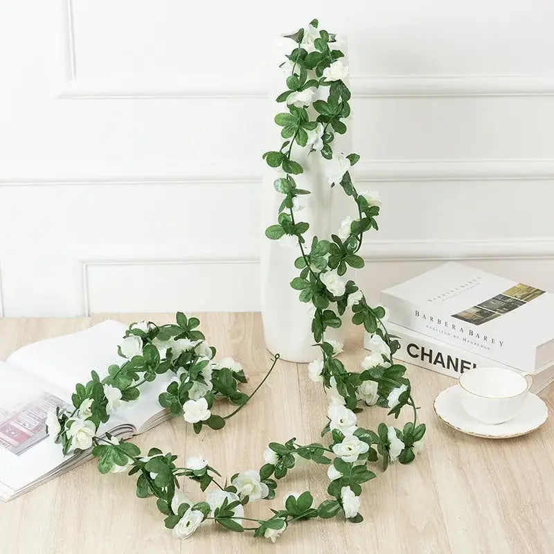 Delicate white rose flowers vine garland with green leaves made of synthetic material for living room decor