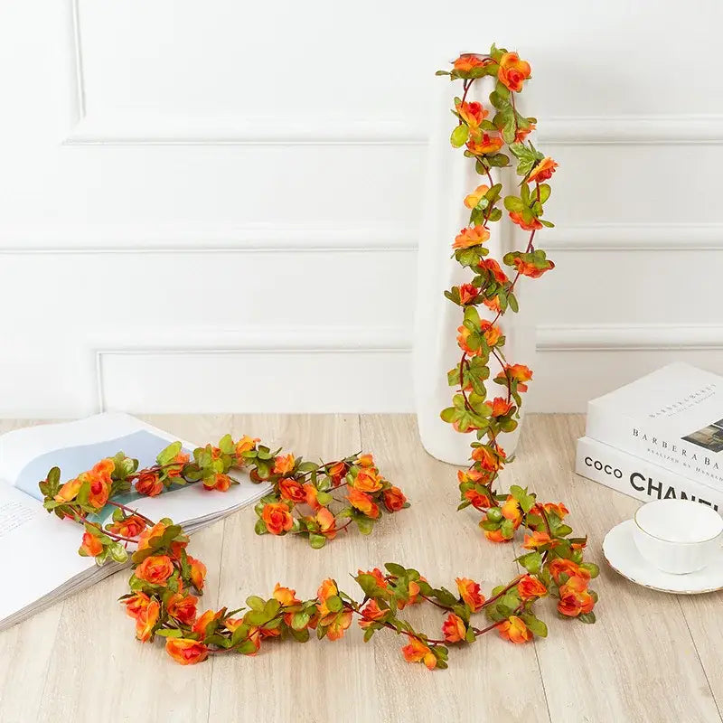 Vibrant orange and green rose flowers vine garland with realistic petals for living room decor