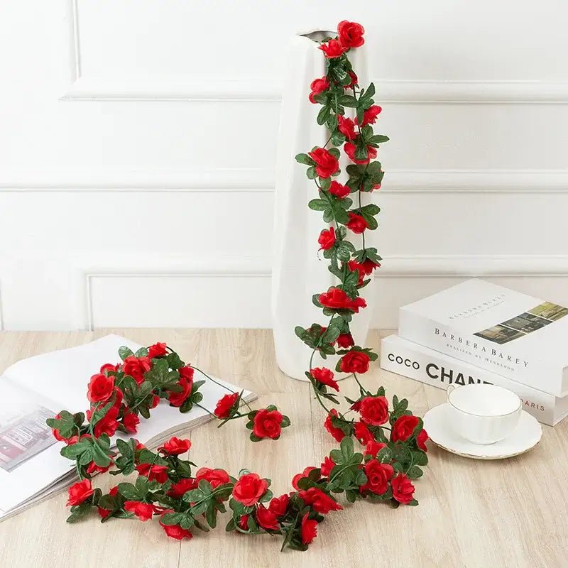 A vibrant red rose flowers vine garland with lush green leaves designed for living room decor and decorative use
