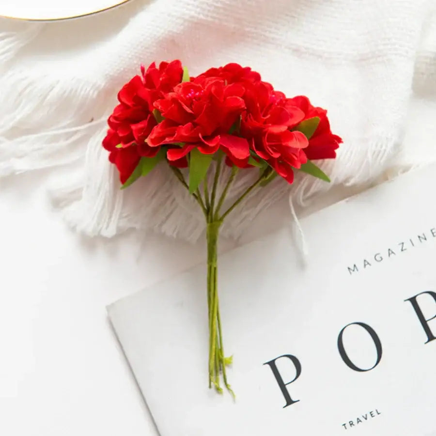 A vibrant red artificial flower stamen bouquet with green stems for living room decor in a compact cluster