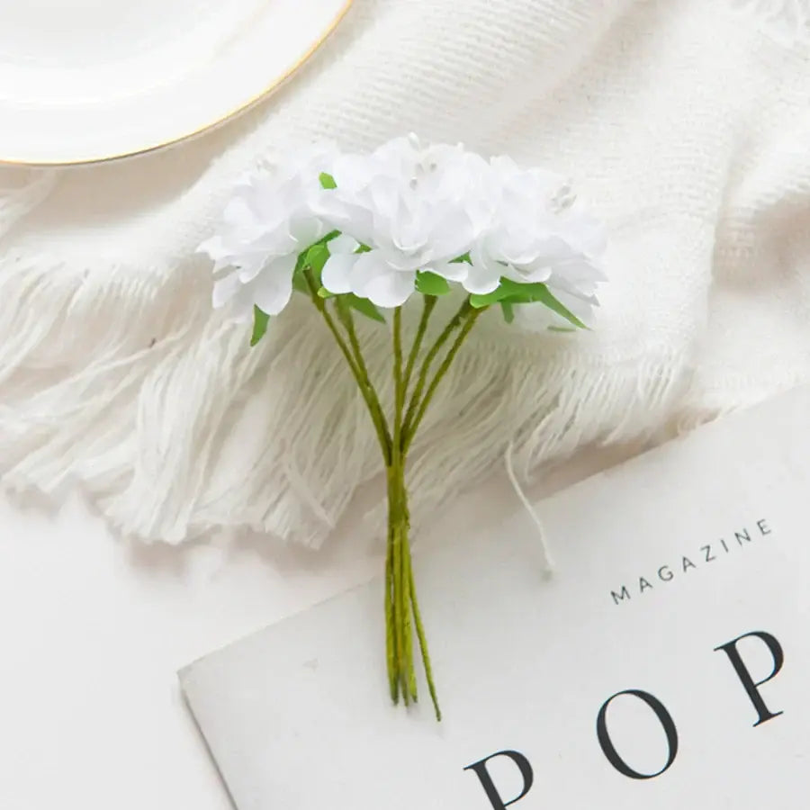 A delicate bouquet of white artificial flower stamen with green stems for vibrant multicolor living room decor
