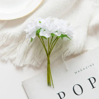 A delicate bouquet of white artificial flower stamen with green stems for vibrant multicolor living room decor
