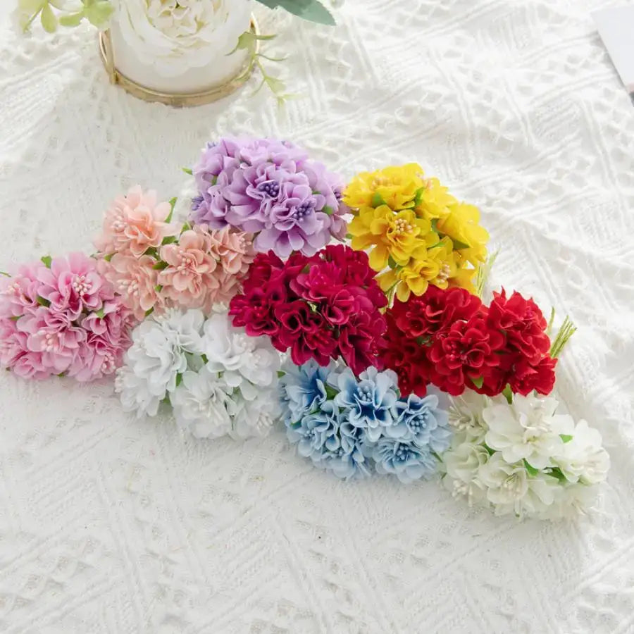 Vibrant multicolor artificial flower stamen bouquet with pink purple yellow red blue and white hues on textured surface