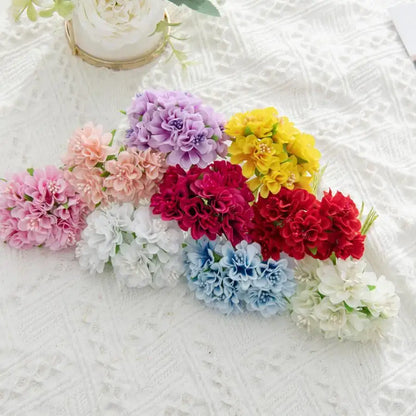 Vibrant multicolor artificial flower stamen bouquet with pink purple yellow red blue and white hues on textured surface