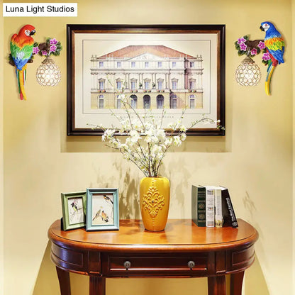 Yellow ceramic vase with ornate gold floral relief paired with vibrant parrot wall sconce led incandescent fluorescent light