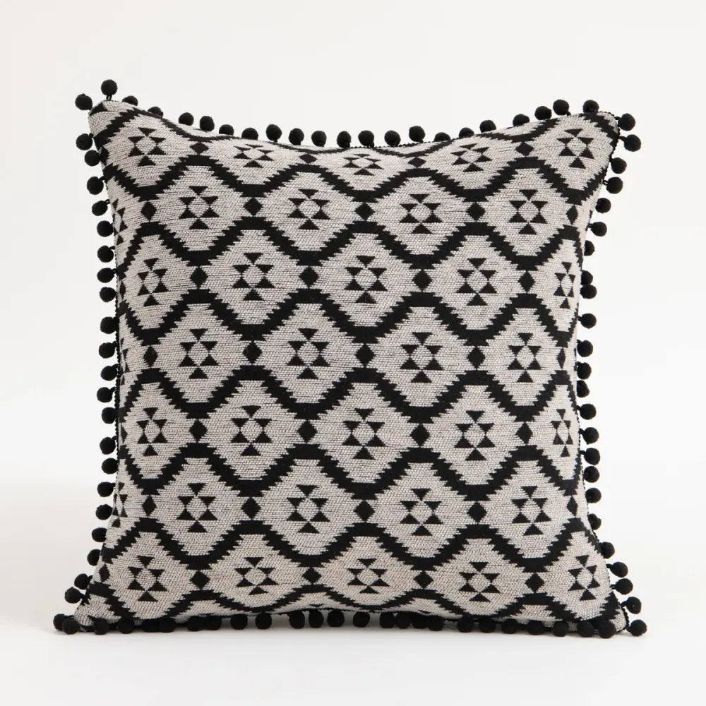 Black and gray geometric-patterned pillow covers with black pom-pom trim for decorbites ethnic boho throw decor