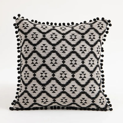 Black and gray geometric-patterned pillow covers with black pom-pom trim for decorbites ethnic boho throw decor