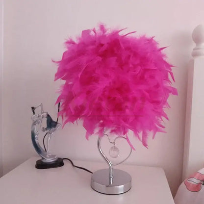 A vibrant pink crystal feather led table lamp with heart-shaped chrome base and crystal accent for bedroom decorbites crystal feather