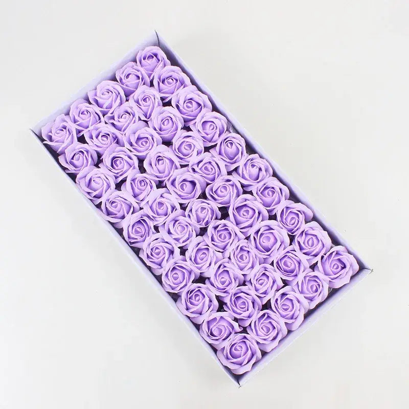 A box of lavender-colored rose-shaped soap bars from the decorbites bath flower set for bathroom decor