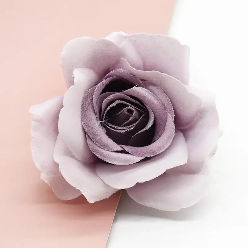 A delicate lavender silk artificial rose with layered petals and subtle sheen from decorbites artificial flowers decor