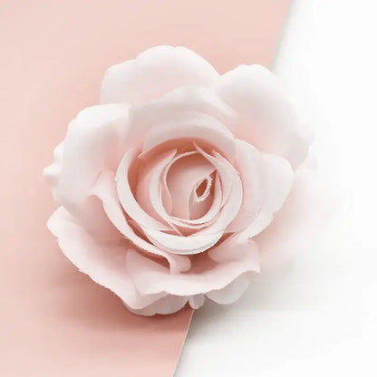 A delicate blush pink silk artificial rose with layered petals from decorbites artificial flowers for wedding decor