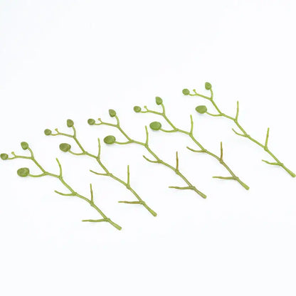 Green plastic decorative branches with small buds in a vibrant silk butterfly orchid bouquet for wedding decor