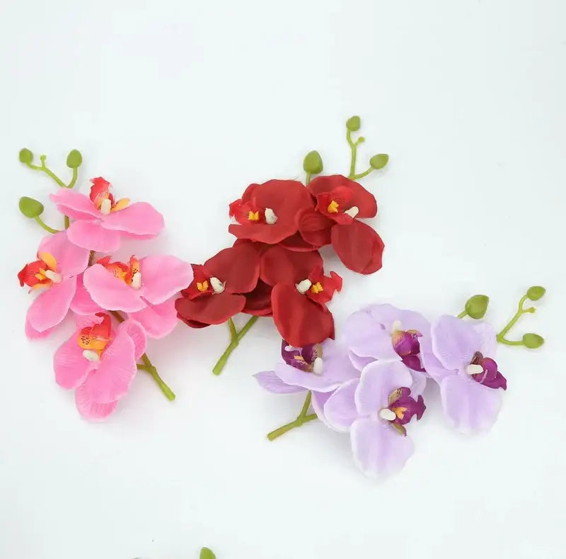A vibrant silk butterfly orchid bouquet featuring pink red and lavender artificial flowers for wedding and home decor