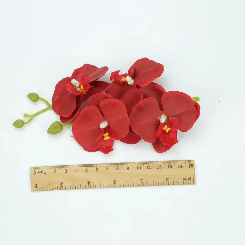 Vibrant silk butterfly orchid bouquet with red artificial petals and green leaves for wedding and home decor