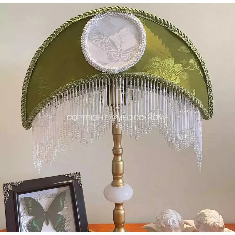 Olive green satin crescent moon lampshade with gold trim white beaded fringe and central lace butterfly motif for desk light