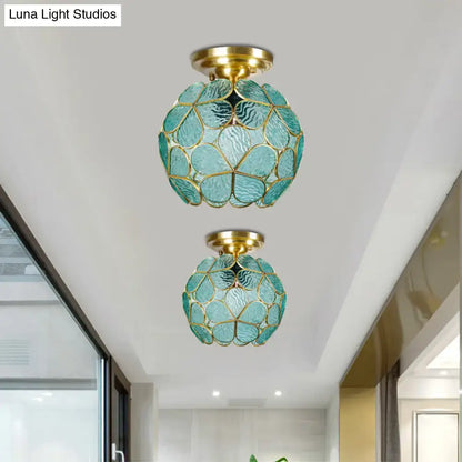 Two teal glass globe ceiling lights with gold-toned frames feature a faceted design in a DecorBites stained glass flower ceiling fixture