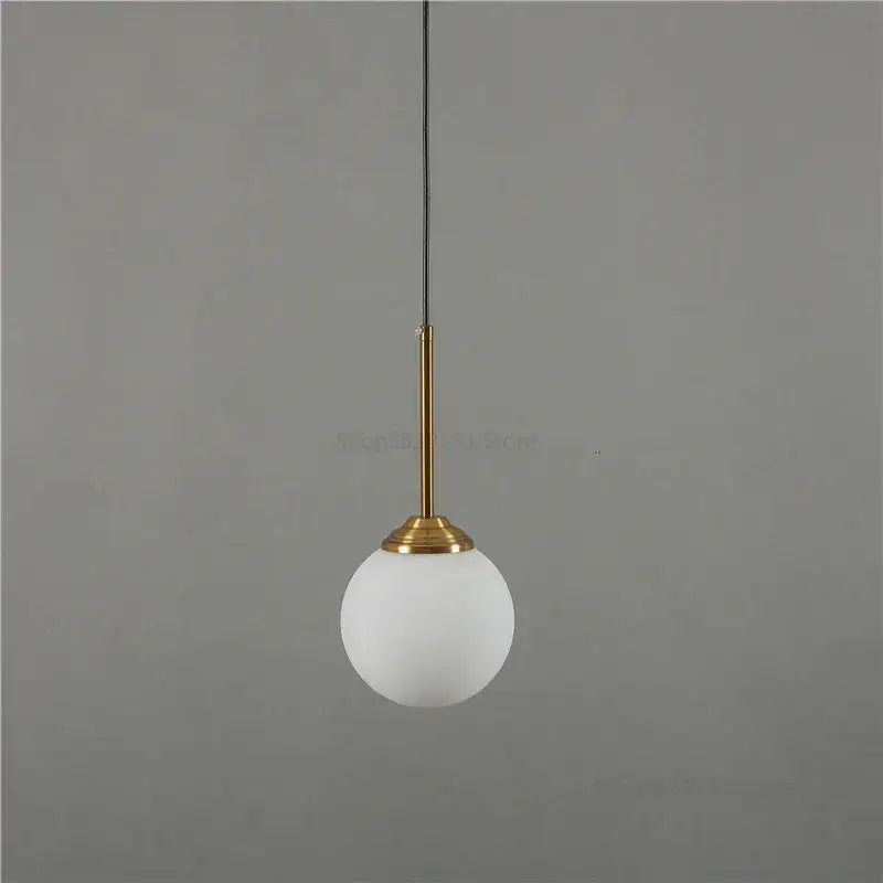 Minimalist pendant light with frosted white glass globe and brass stem on black cord for decorbites gray glass ball decor