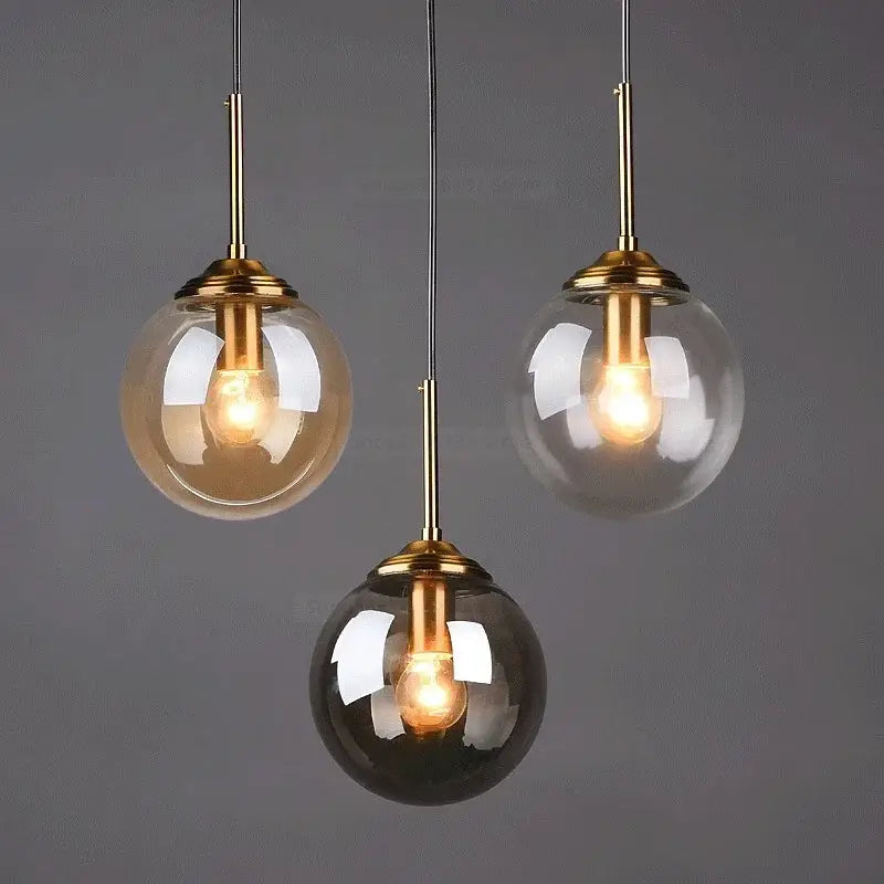 Vintage amber and gray glass ball pendant lights with brass fixtures featuring clear and smoked amber shades for decorbites gray glass decor