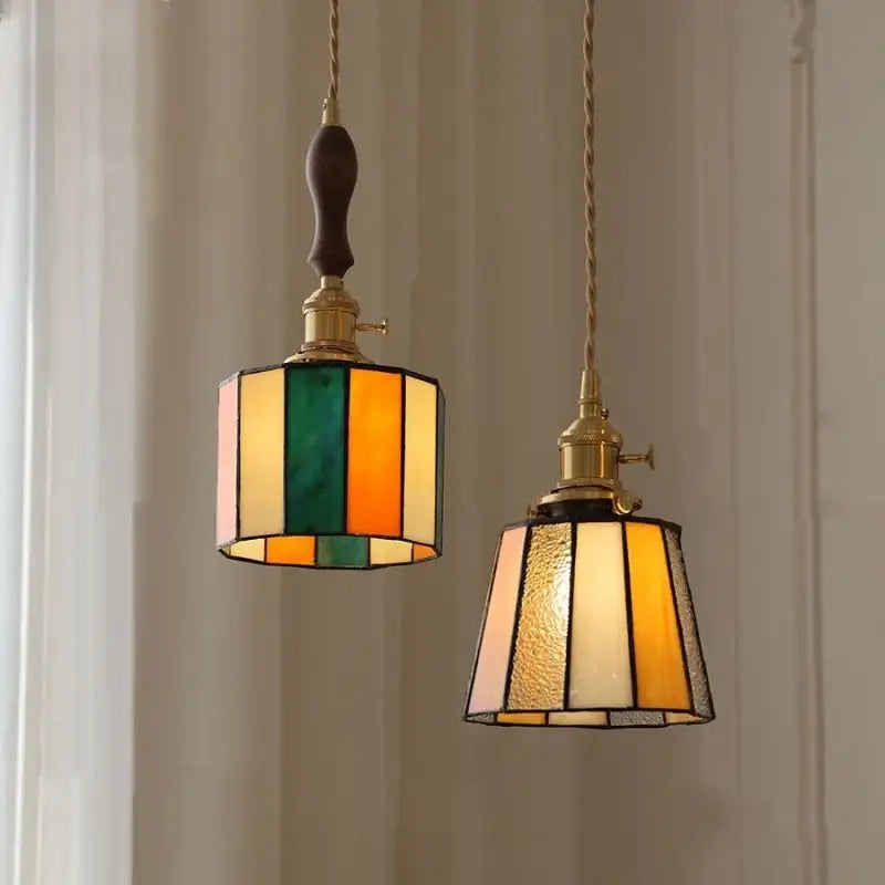 Two vintage-style stained glass pendant lamps with knob switch featuring amber cream and multicolor striped designs by decorbites copper knob