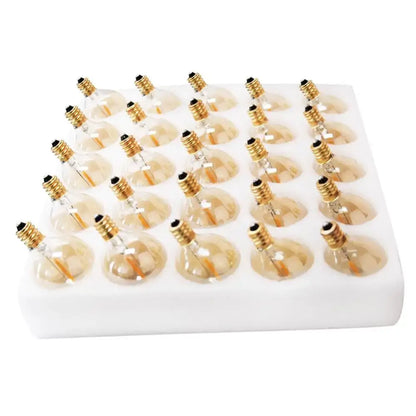 A set of 24 decorbites g40 vintage amber glass led string warm white bulbs with golden bases in a white foam tray