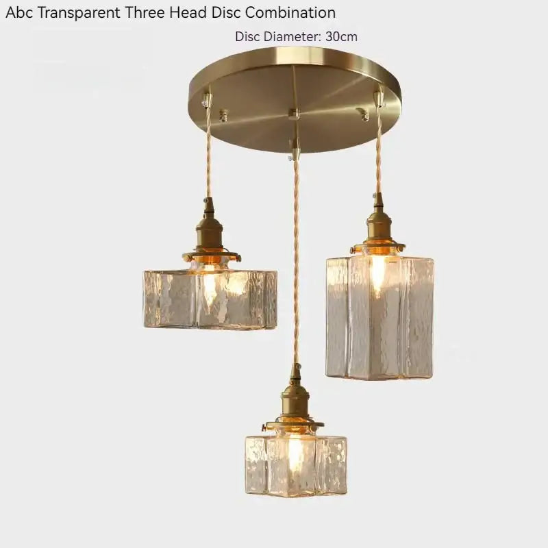 Vintage amber glass pendant light with transparent textured glass pendant shades and polished brass accents for dining room