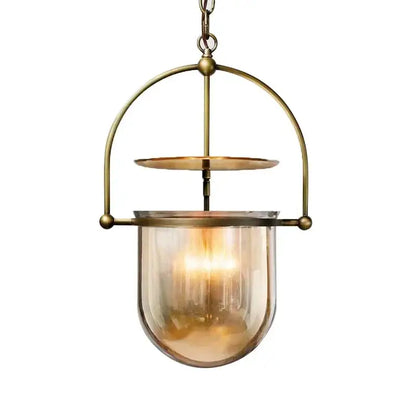 Vintage amber glass pendant light with antique brass frame and warm amber shade for dining room use