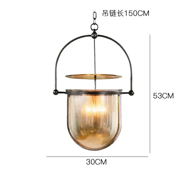 Vintage amber glass pendant light with black metal frame and hanging chain for dining room use