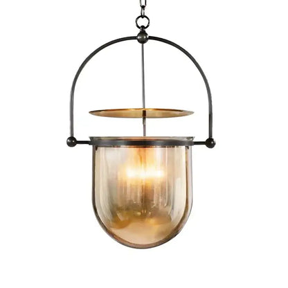 Vintage amber glass pendant light featuring a warm amber glass pendant with black metal frame and brass accent for dining room
