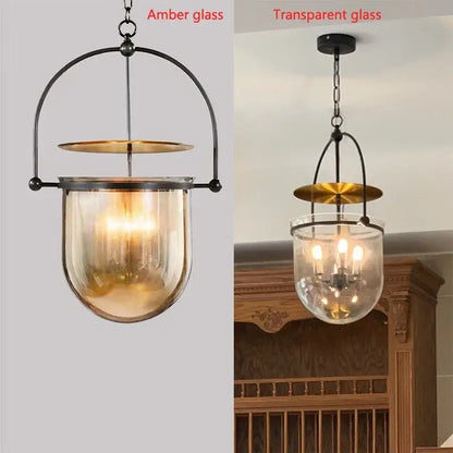 Vintage amber glass pendant light with brass accent and arched black metal frame for dining room use