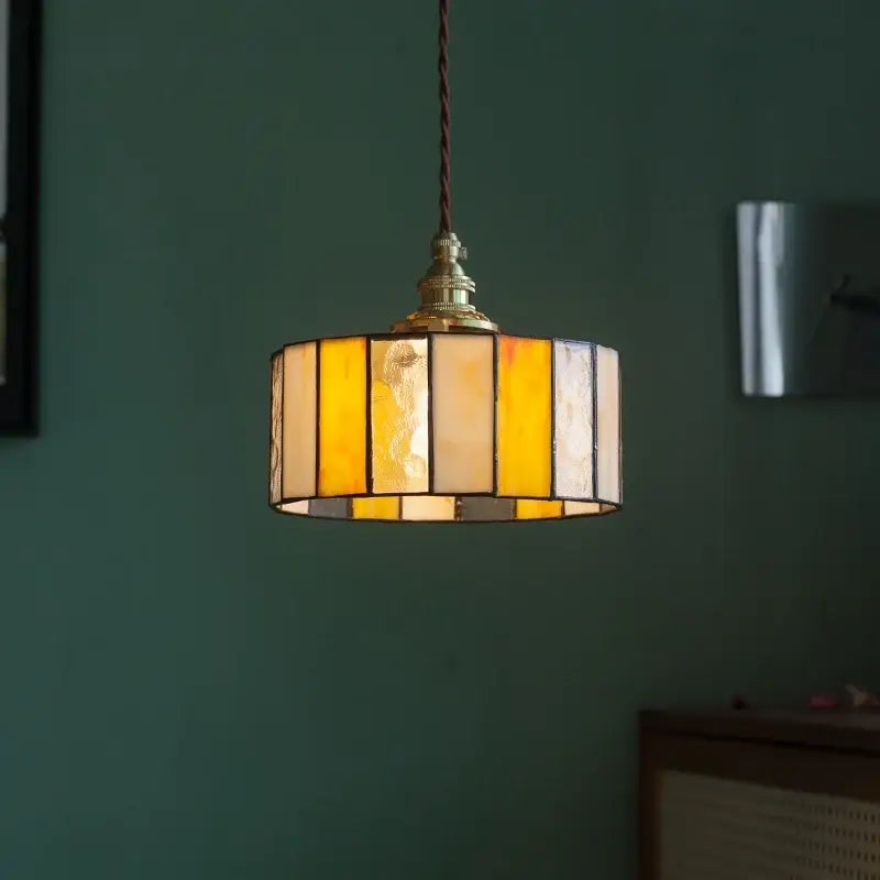 A warm-toned vintage amber stained glass pendant light with brass frame for decorbites colorful led kitchen decor