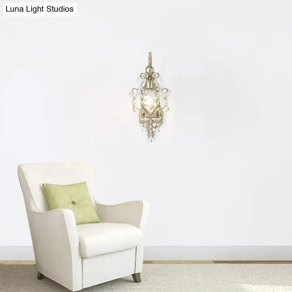 Vintage antique brass wall lamp featuring clear crystal beaded strand and a gold-toned illuminated glass panel