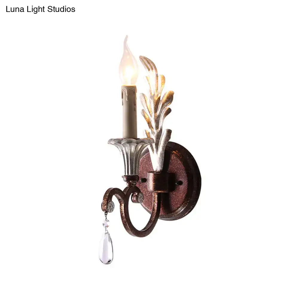Vintage antique brass and silver leaf wall light fixture with clear crystal teardrop pendant for bedroom use
