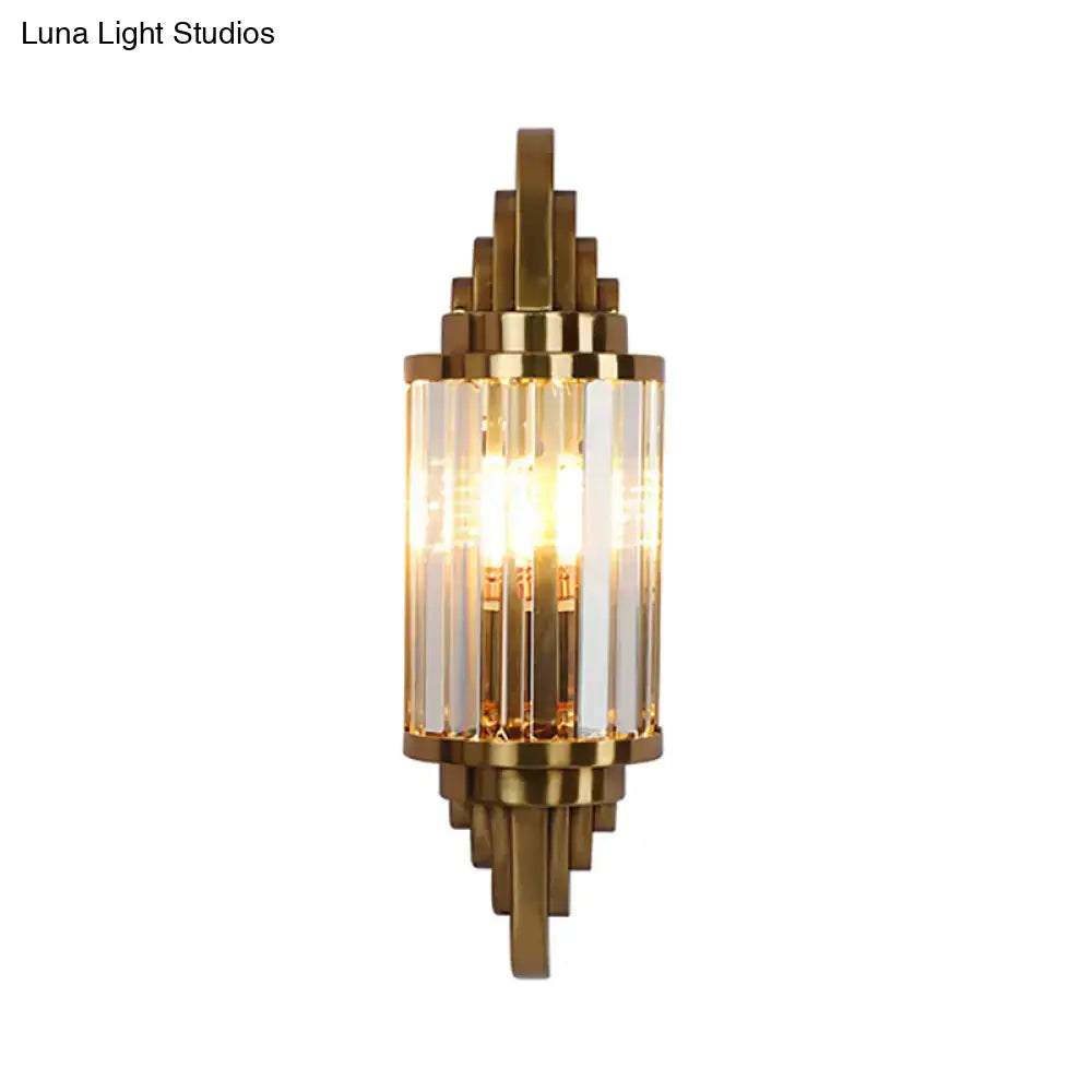 Gold-toned vintage art deco wall sconce with clear crystal prism rods and geometric metal framing for living room use