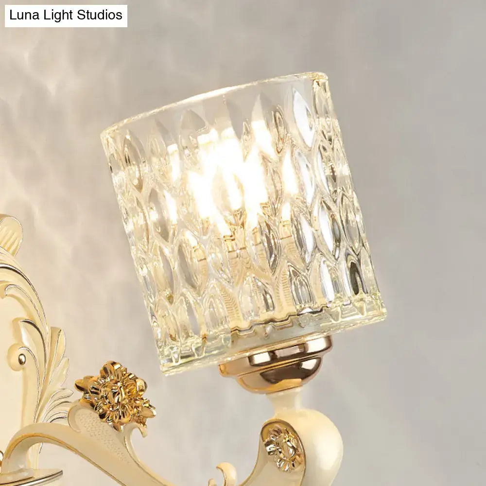 Vintage beige and gold glass wall light featuring a clear faceted crystal lampshade and ornate metal arm for bedroom use