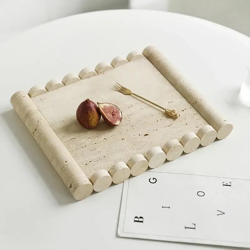 Beige travertine marble serving tray with rounded cylindrical edges and textured surface for kitchen use