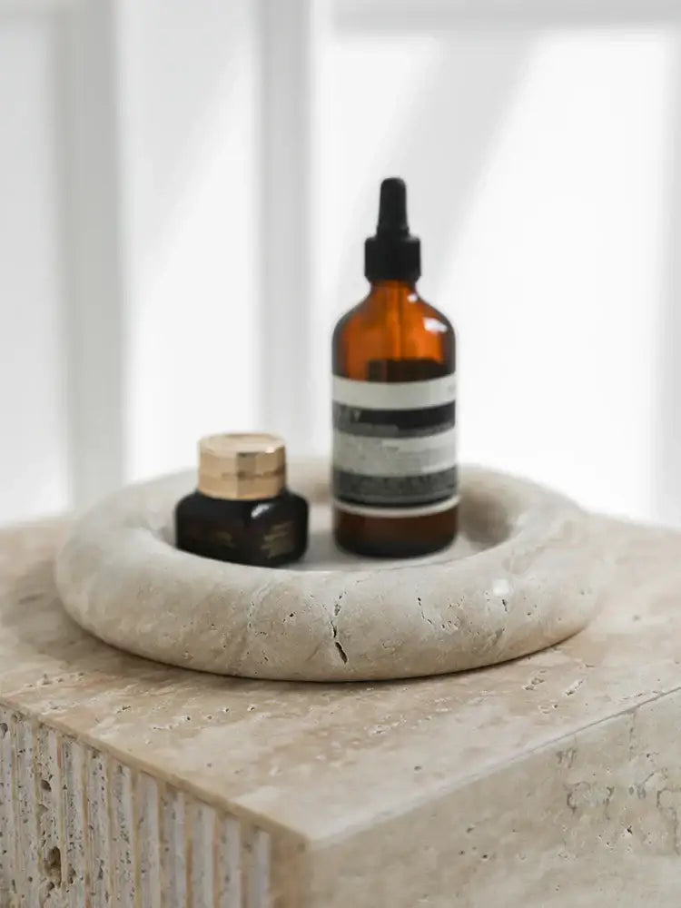 Beige travertine serving tray with textured finish holding dark amber dropper bottle for bedroom vanity decorbites beige travertine