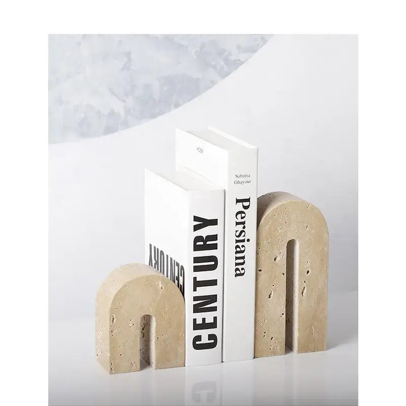 Beige travertine stone arched bookends with smooth curved design for vintage living room decor by decorbites