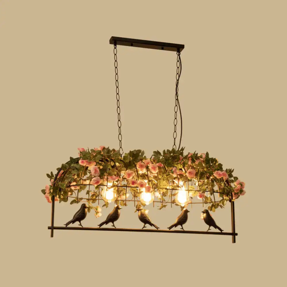 Vintage bird cage iron hanging light with black metal frame, pink roses, green foliage, and five bird figurines