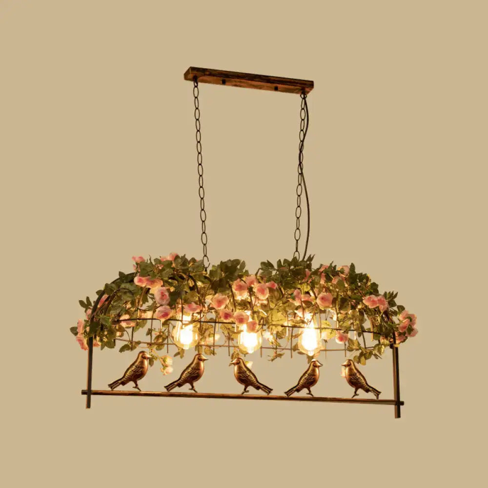 Vintage bird cage iron hanging light featuring five bronze bird figurines under pink rose arch for dining room use