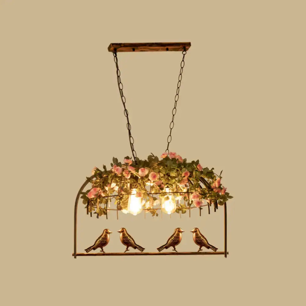 Vintage bird cage iron hanging light with rustic bronze bird pendant, wooden top, pink roses, and greenery for dining room