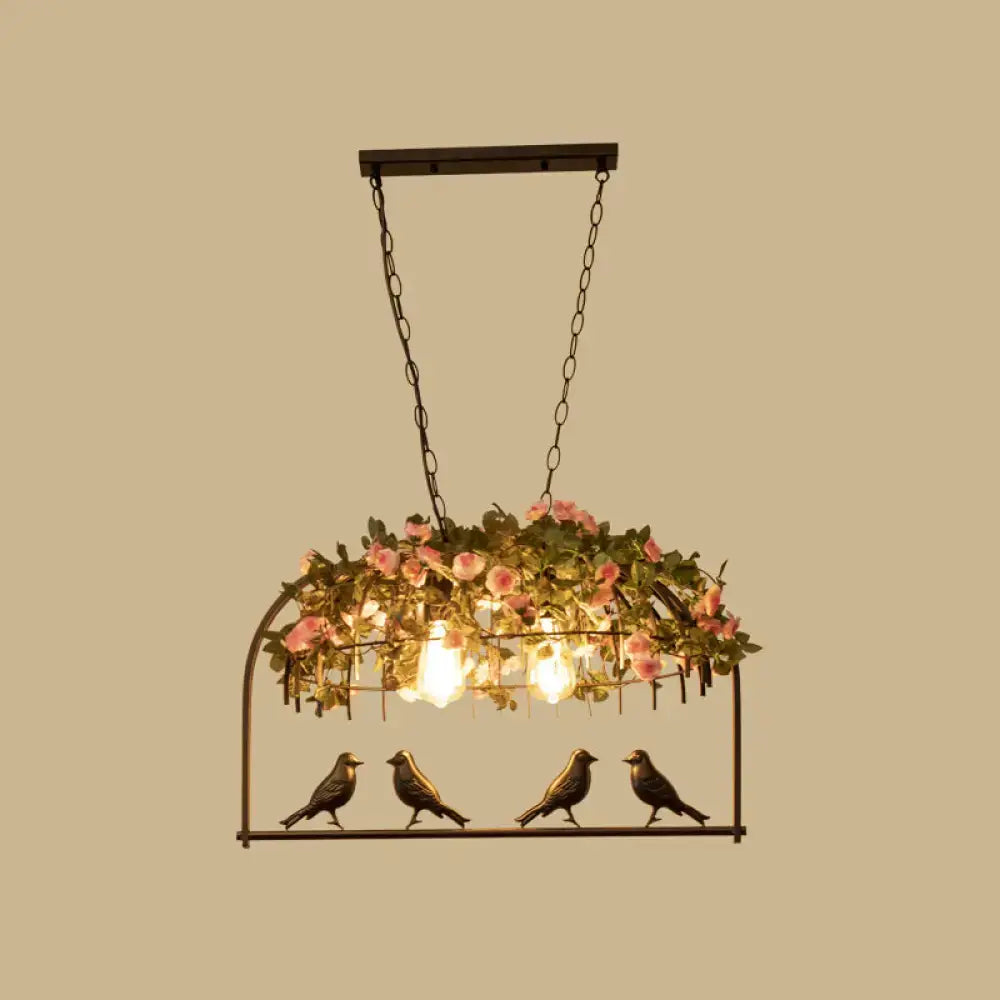 Vintage bird cage iron hanging light with black metal frame pink roses greenery and three exposed bulbs with bird figurines