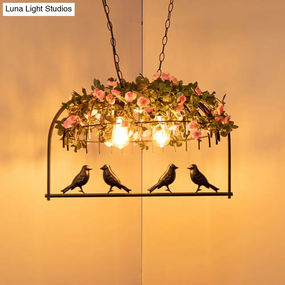 Black metal bird cage iron hanging light with four sculpted birds pink roses and greenery for dining room use