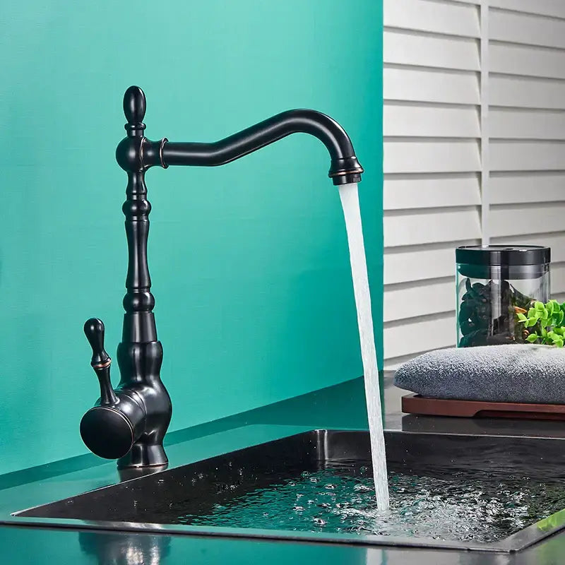 Vintage black bronze kitchen faucet with ornate single lever handle and curved spout with water flowing, decorbites black bronze design