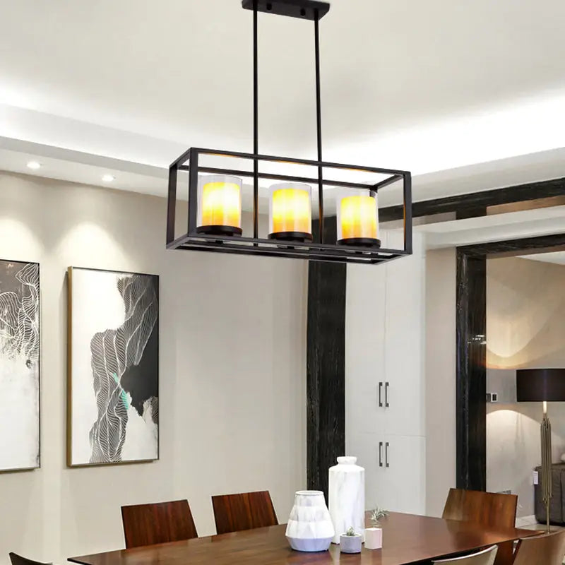 Black metal cylinder pendant light with three warm yellow glass candle bulbs for dining room lighting