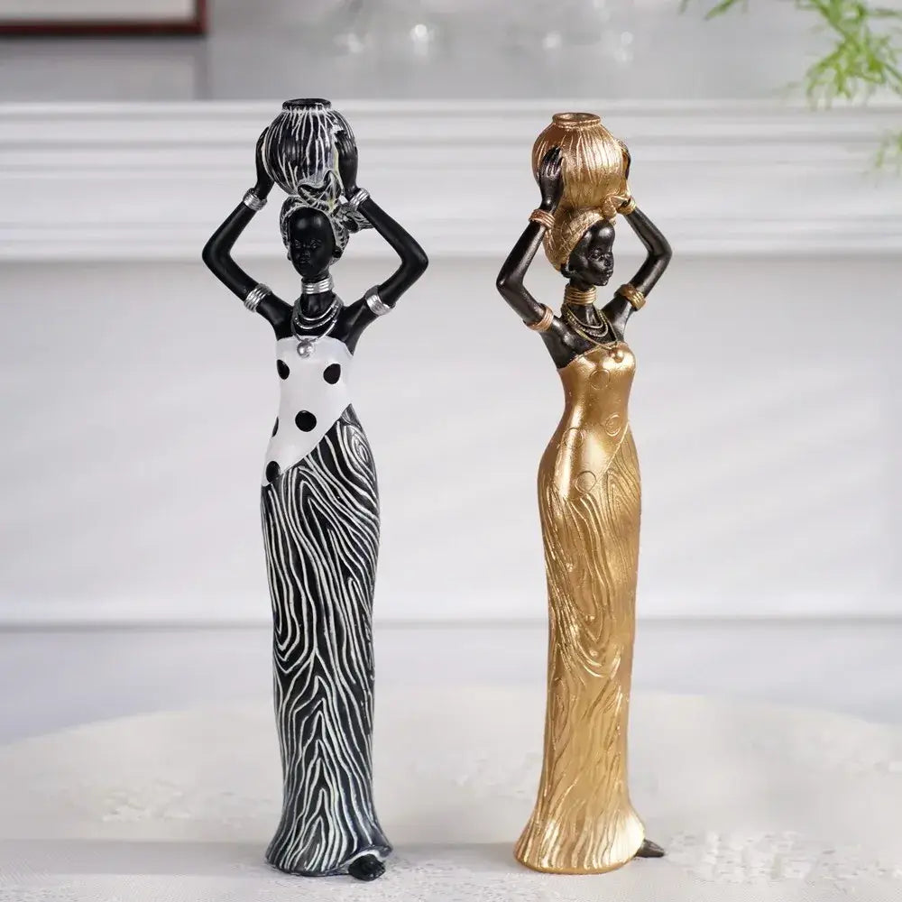 Two elegant african women resin sculptures in black and white zebra stripes and smooth gold finish for decorbites decor