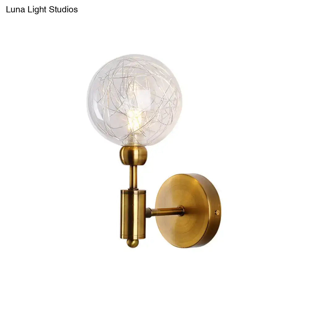Vintage black and gold clear glass wall sconce with antique brass finish and intricate internal wire e26 e27 bulb design