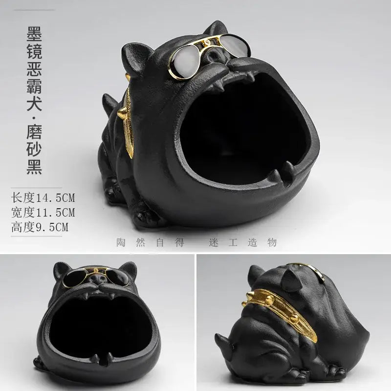 Vintage black and gold decorbites ceramic dog ashtray shaped like a bulldog with gold-rimmed sunglasses and collar