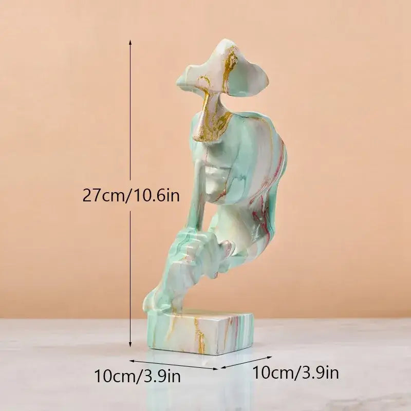 A 27cm silence golden face abstract sculpture in translucent mint-green resin with gold leaf accents for office decor