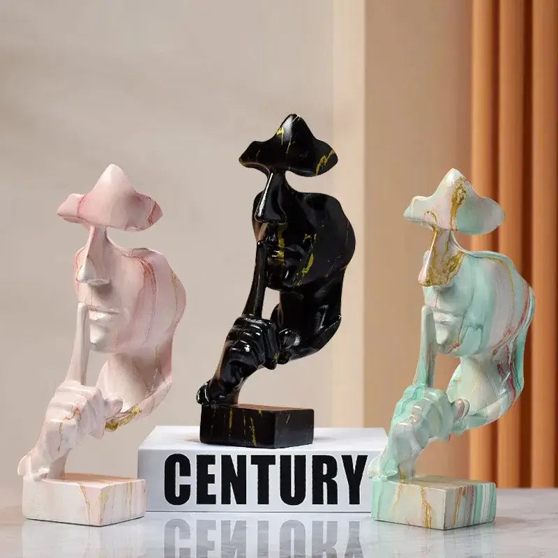 Three abstract sculptural figures including a vintage black and gold face 27cm silence golden office decor piece
