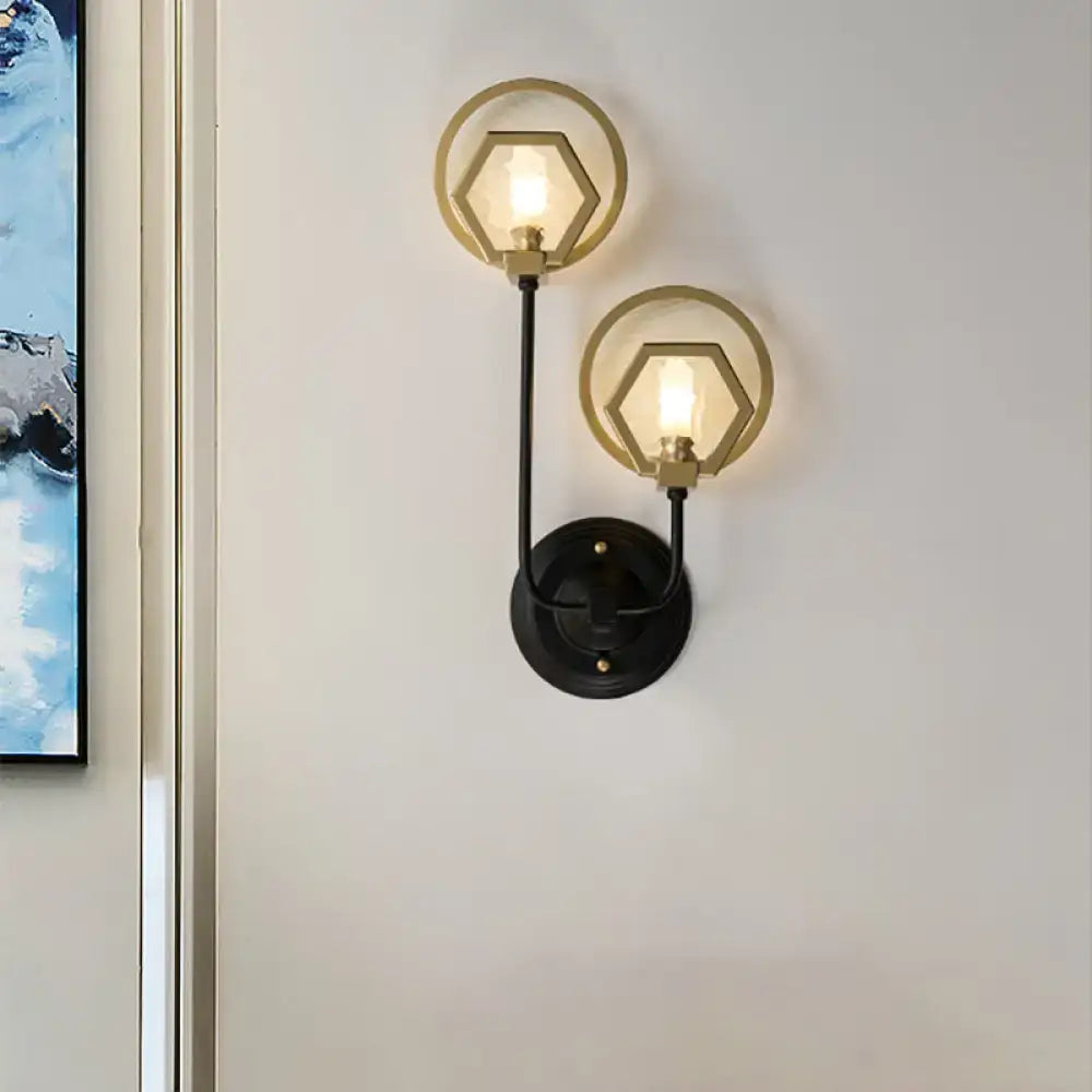 Modern two-light wall lamp with black finish and brass hexagonal glass shades for elegant living space lighting